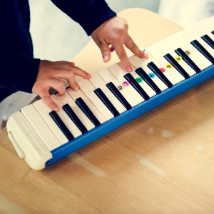 Boy playing piano music toy